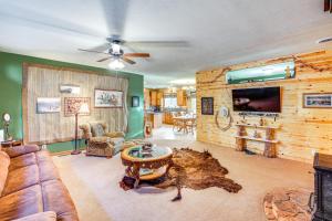 a living room with a couch and a tv at 5 Mi to Town Mtn-View Gem with Deck in Hot Springs in Hot Springs