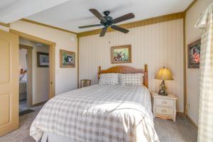 a bedroom with a bed and a ceiling fan at Deck and Fire Pit! Cabin Half-Mi to Tunica Lake in Tunica