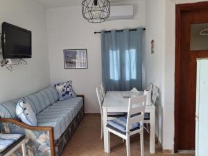 a living room with a couch and a table at Omisu Apartments in Kithnos