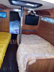 a bed in the middle of a room with a tv at Miraflores in Boulogne-sur-Mer