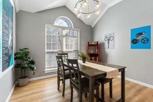 a dining room with a table and chairs at Coler Lounge Cyclist's Dream Home with Hot Tub in Bentonville