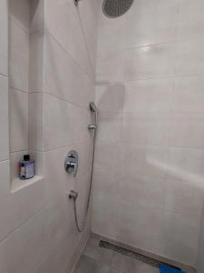 a shower in a bathroom with a shower at Студія поряд з замком Любарта in Luts'k +11 photos