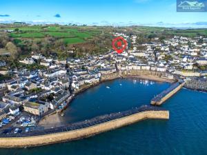 an aerial view of a town with a red circle at Boatsman's Cottage- sleeps 4- Garage- Mousehole in Mousehole