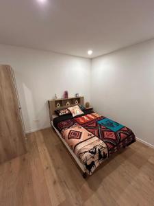 a bedroom with a bed in the corner of a room at Évasion cosy, proche de Paris in Argenteuil