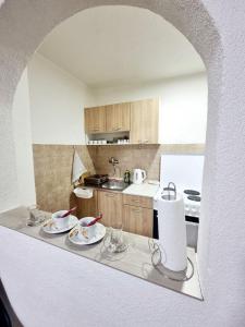 a kitchen with a table with dishes on it at Apartman Family in Sarajevo