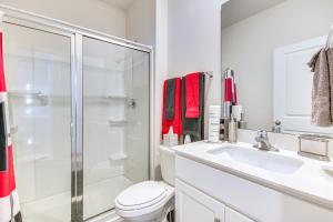 a bathroom with a shower and a toilet and a sink at 9 Mi to Old Salem Spacious Family Home with Yard! in Winston-Salem +19 photos