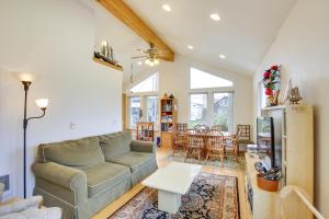 a living room with a couch and a table at 1 Block to Twin Rocks Beach Pet-Friendly Cottage in Rockaway Beach