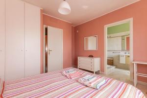 a bedroom with a large bed and a bathroom at B&B Mareya in Cagliari