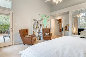 a bedroom with a bed and two chairs at Hot Tub, Fire Pit Retreat in The Woodlands! in The Woodlands