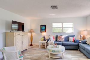 a living room with a blue couch and a table at Townhome Near Hobe Sound Beach, Hiking and Golfing! in Hobe Sound