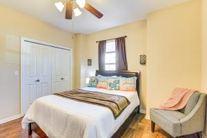 a bedroom with a bed and a chair at Half-Mi to Galveston Strand Charming Home with Yard in Galveston +18 photos
