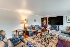 a living room with couches and a flat screen tv at Bring a Pet West Valley City House with Grill in West Valley City