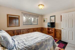 a bedroom with a bed and a flat screen tv at Bring a Pet West Valley City House with Grill in West Valley City