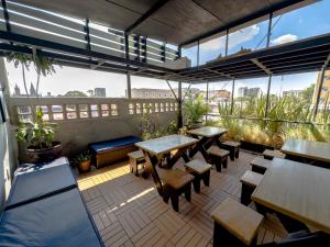 un patio con mesas y bancos en un balcón en Estudios by Flor y tierra, en Guadalajara