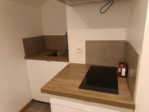 a kitchen with a counter with a laptop on it at Les hortensias in Lannion