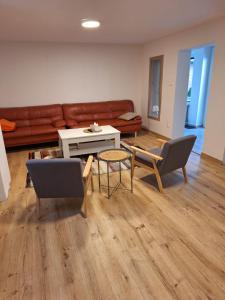 a living room with a couch and a table and chairs at UBYTKO POLEŠOVICE in Polešovice