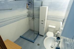 a bathroom with a shower and a toilet and a sink at Vitamine Sea in Alexandroupoli +14 photos