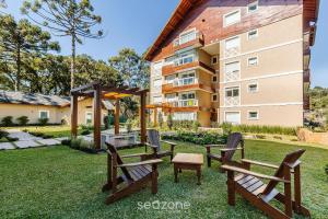 a group of benches in front of a building at Lindo Apto c/ 2 Quartos em Canela DAL207 in Canela
