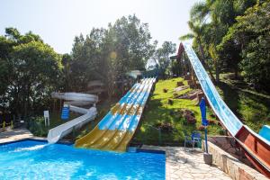 a pool with a water slide in a park at Águas de Palmas Resort in Governador Celso Ramos