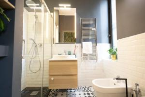 a bathroom with a sink and a shower at Vittadini Rooms in Milan +6 photos