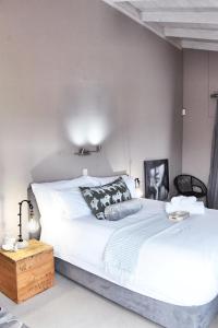 a bedroom with a large white bed in a room at 4on Pebbles Holiday Home in Swakopmund +20 photos