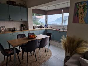a kitchen with a table and chairs in a kitchen at Sea View Luxury Studios in Vrachonisída Palaiókastro