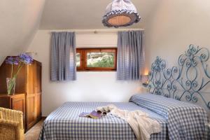 a bedroom with a bed with a blue and white blanket at Le Roccette Club in Tropea