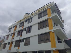 a white building with a sign on it at Orquídea's Hotel in Piura