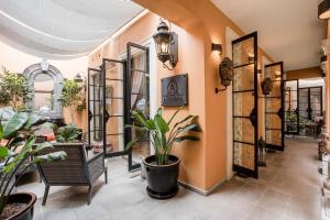 a hallway with plants and chairs in a store at Artesana - Privately Owned Rosewood Residence in San Miguel de Allende +58 photos