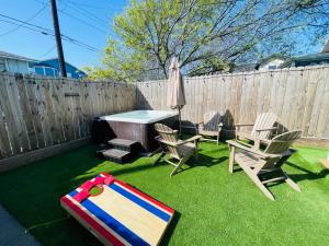 a backyard with a table and chairs and an umbrella at Tourist Hotspot Walk to Beach Hangout & Relax in Galveston