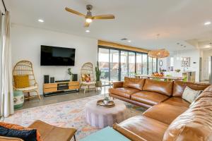 a living room with a couch and a tv at Families Welcome Phoenix Home with Backyard Oasis in Phoenix