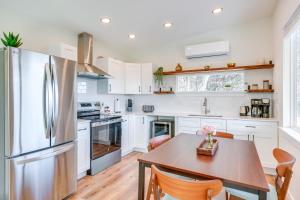a kitchen with a wooden table and a refrigerator at Close to Canyon Lake Cabin - Boat Ramp and Hot Tub in Canyon Lake