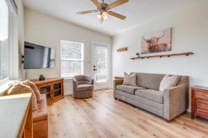 a living room with a couch and a tv at Close to Canyon Lake Cabin - Boat Ramp and Hot Tub in Canyon Lake
