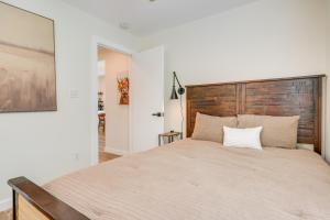 a bedroom with a large bed with a wooden headboard at Close to Canyon Lake Cabin - Boat Ramp and Hot Tub in Canyon Lake