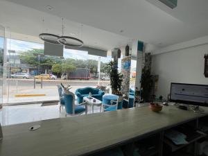 an office with a desk and chairs and a large window at Mar Inn Hotel in Ríohacha