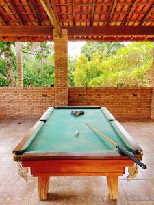 a pool table with two cuesticks on top of it at Sítio Pand'Oro in Atibaia