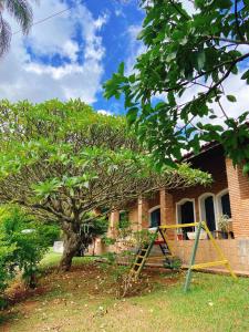 a house with a playground in front of it at Sítio Pand'Oro in Atibaia