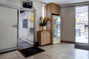 a lobby with a door with a vase of flowers at Contagem Centro Hotel in Contagem