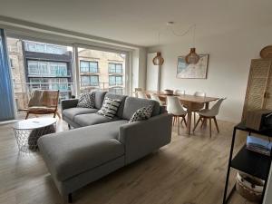 a living room with a couch and a table at Residentie Hippocampe in Wenduine