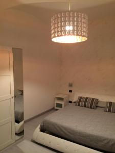 a bedroom with a bed and a chandelier at B&B Massimo Centro in Catania