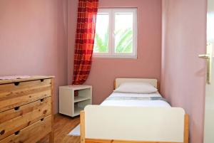 een kleine slaapkamer met een bed en een raam bij Apartment Ana Banana in Zadar