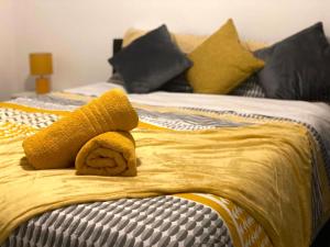a yellow stuffed animal sitting on top of a bed at The Hanham Retreat in Bristol