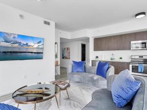 a living room with two couches and a table at X-Lounge - High-Rise with Rooftop Pool & Panoramic City Views in Miami