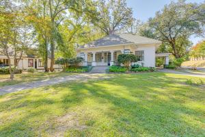 a white house with a large yard at 1 Mi to Dtwn Meridian Historic Home with Porch! in Meridian