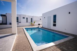 a swimming pool in the backyard of a house at 'Casa 30' Villa nearby Mambo-Beach in Willemstad