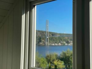 a window with a view of a bridge over a lake at Apartment with sea view in Stathelle