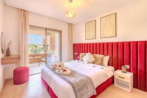 a bedroom with a large bed with a red headboard at Luxury apartments prestigia in Marrakech +123 photos