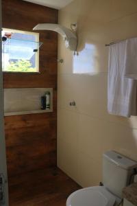 a bathroom with a toilet and a window at A casa do lago in Aracaju