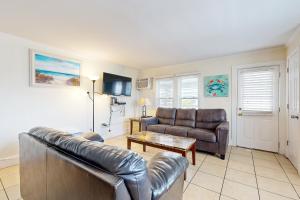 a living room with a leather couch and a table at Casa Sophia #12 in Ocean City