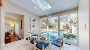 a dining room with a glass table and chairs at 20 Port Tack in Hilton Head Island